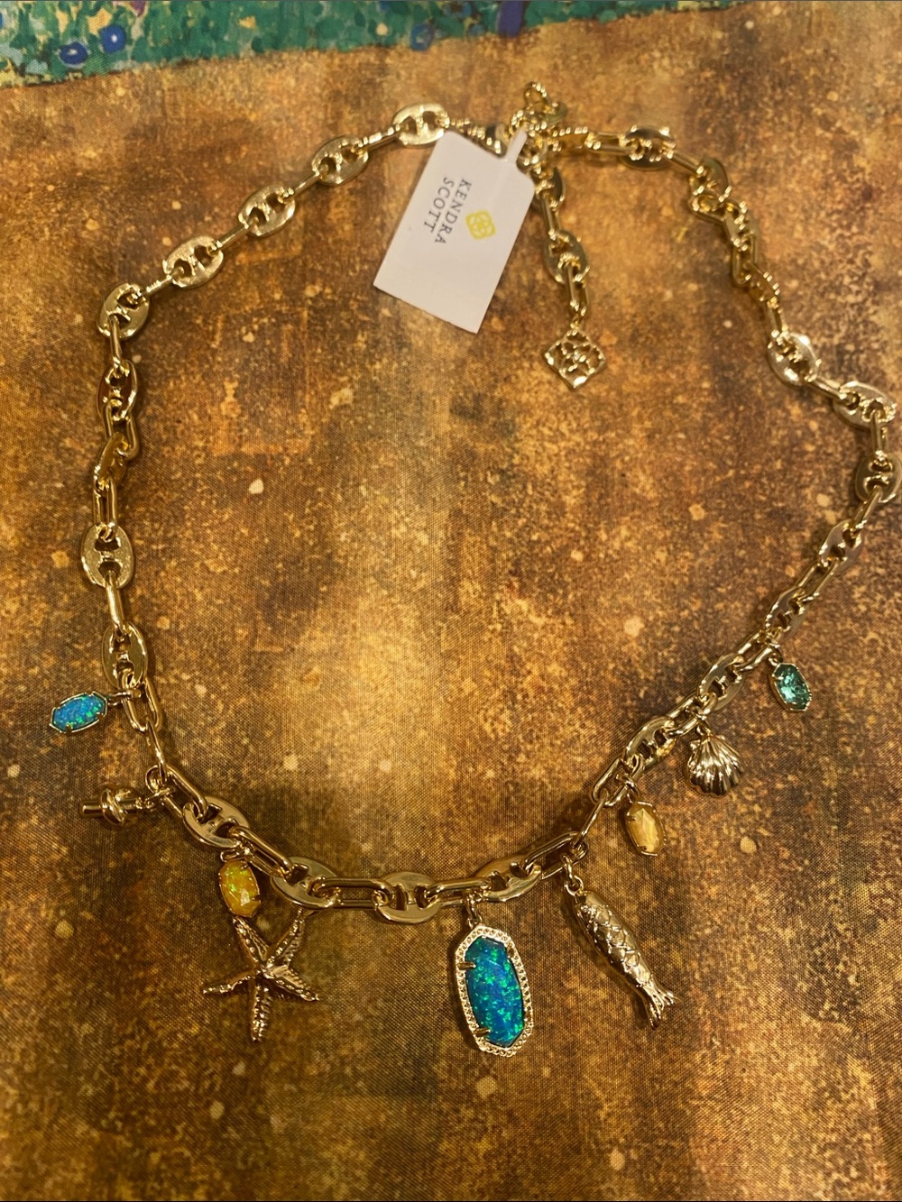 Beautiful Kendra Scott Gold Charm Necklace with Blue and Yellow Opal Accents